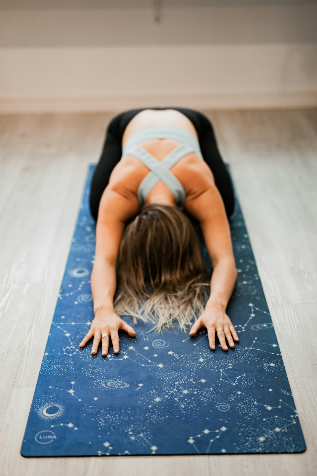 our-journey-02 Girl on celestial, space, astro yoga mat, childs pose